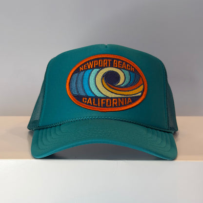 Jade colored trucker hat with a colorful Newport Beach California embroidered logo on a patch.