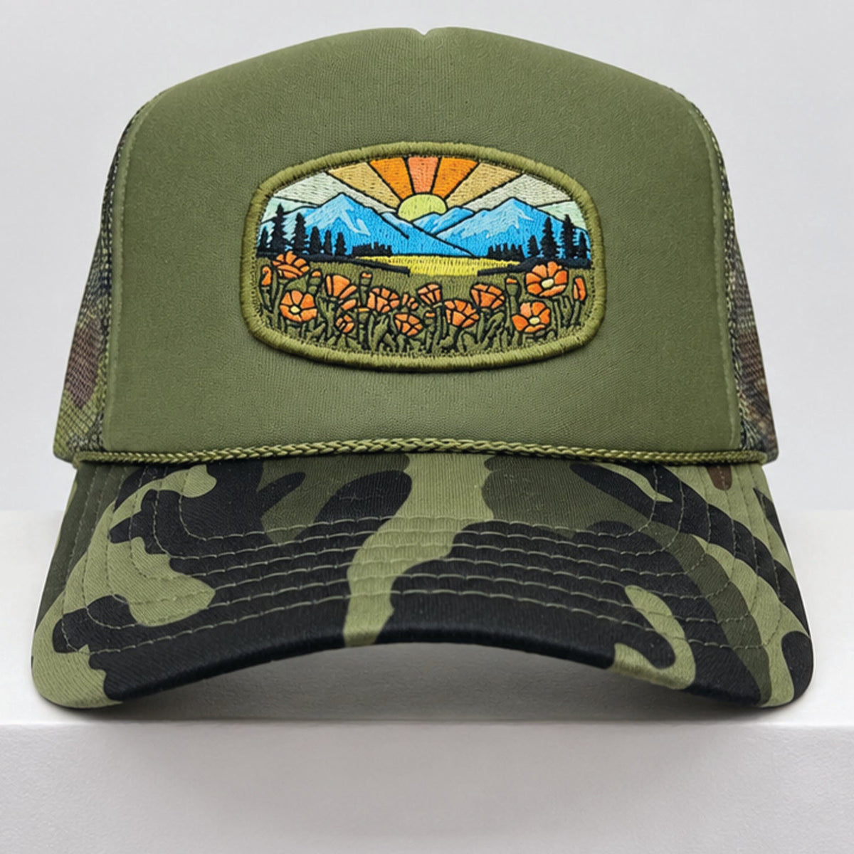 Port Sandz Olive Camo California Poppy Trucker Hat. Vicose embroidered patch on front picturing sun and rays, mountains and California's State Flower, the golden poppy in fields. 