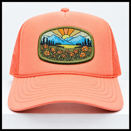 Port Sandz peach colored California Poppy Mesh-Back Trucker Hat. Vicose embroidered patch on front picturing sun and rays, mountains and California's State Flower, the golden poppy in fields. 