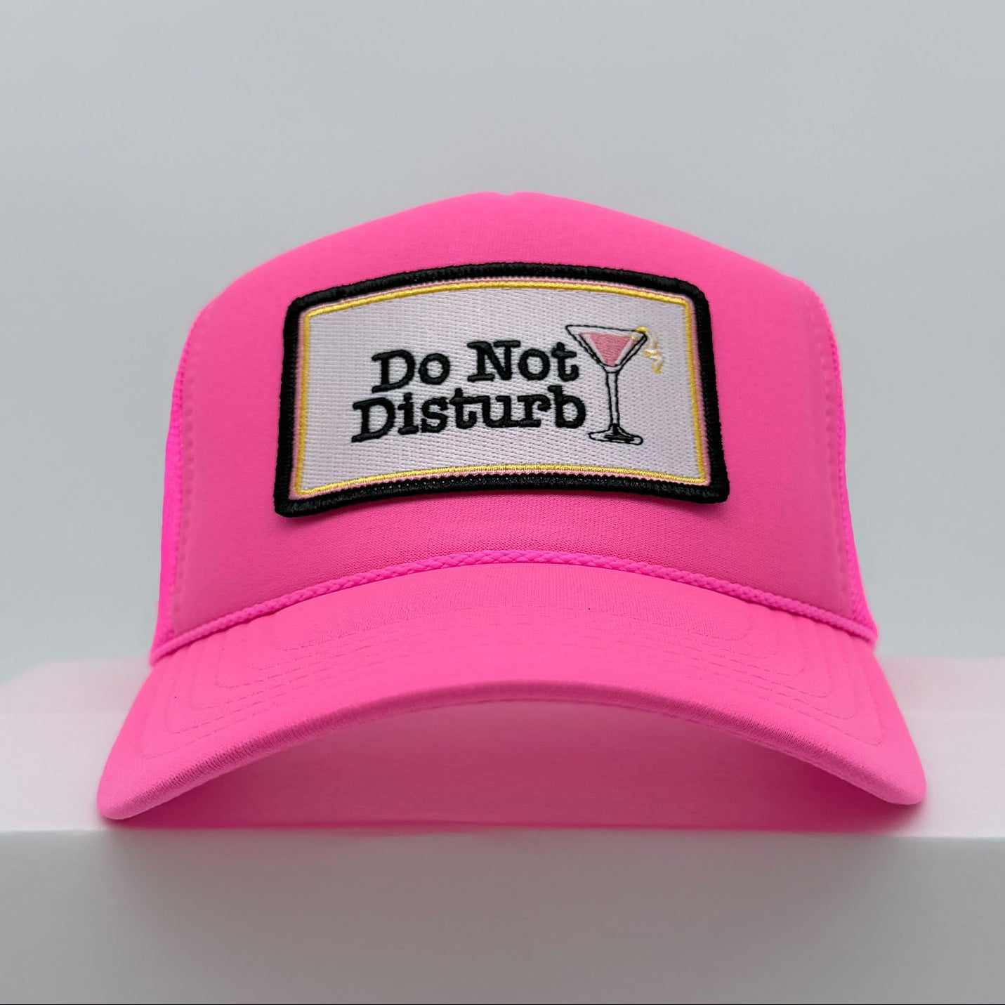 Port Sandz Do Not Disturb neon pink trucker hat with cosmopolitan glass on patch - front view